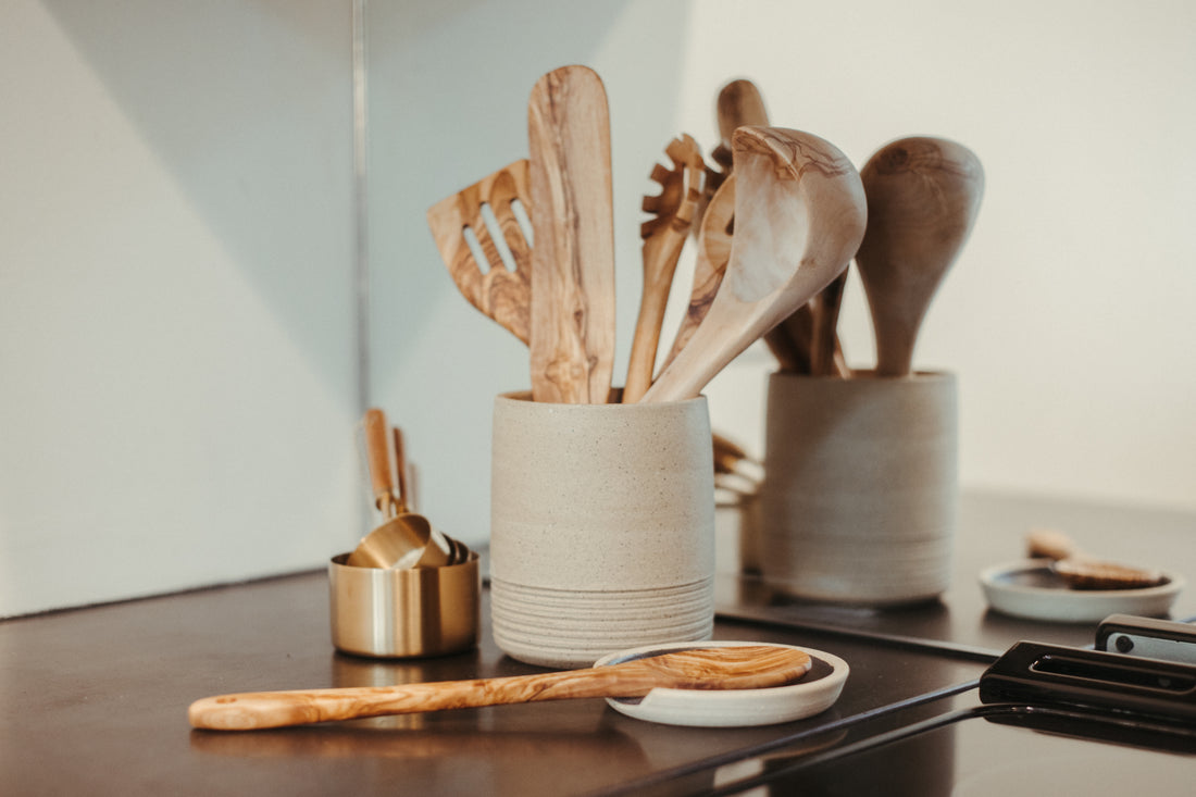 olive wood kitchen utensils next to the stove